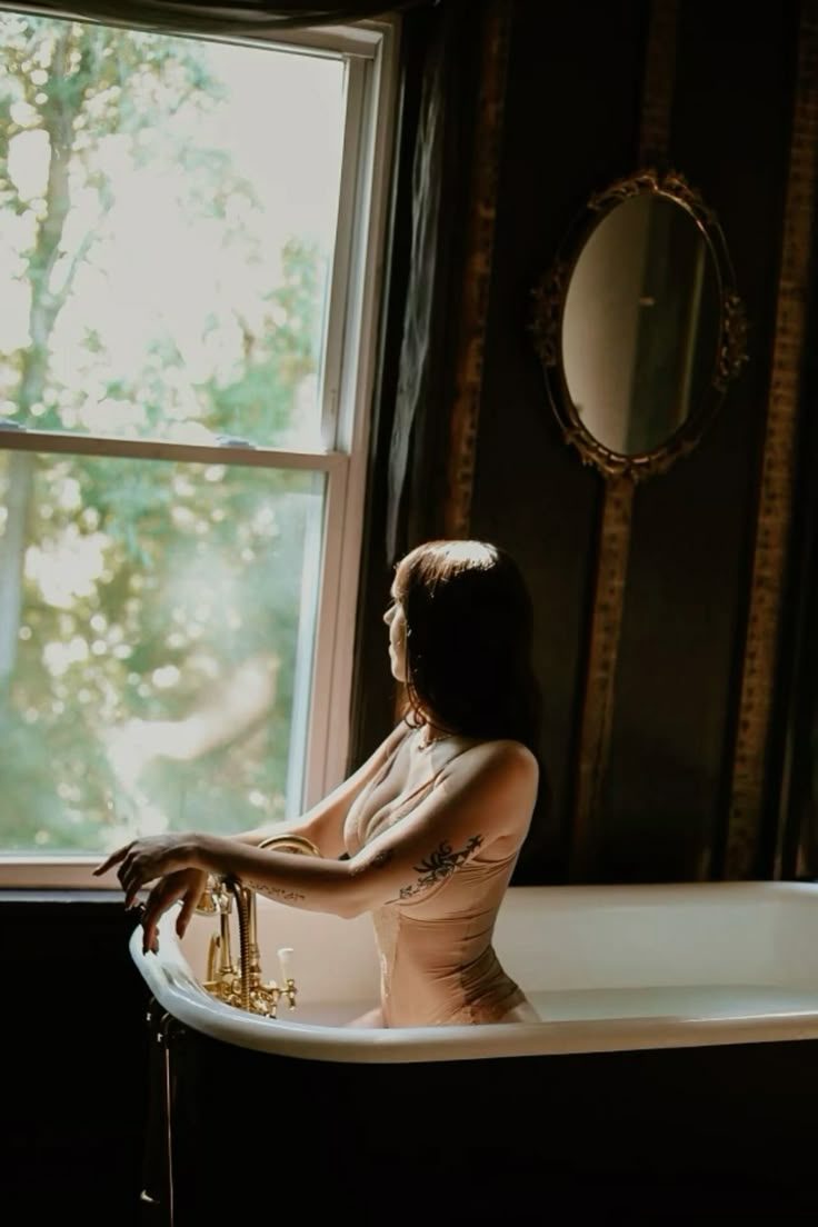 A bath drawn beside an open window